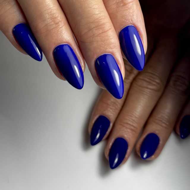 Royal blue glossy almond nails by The Nail Editor