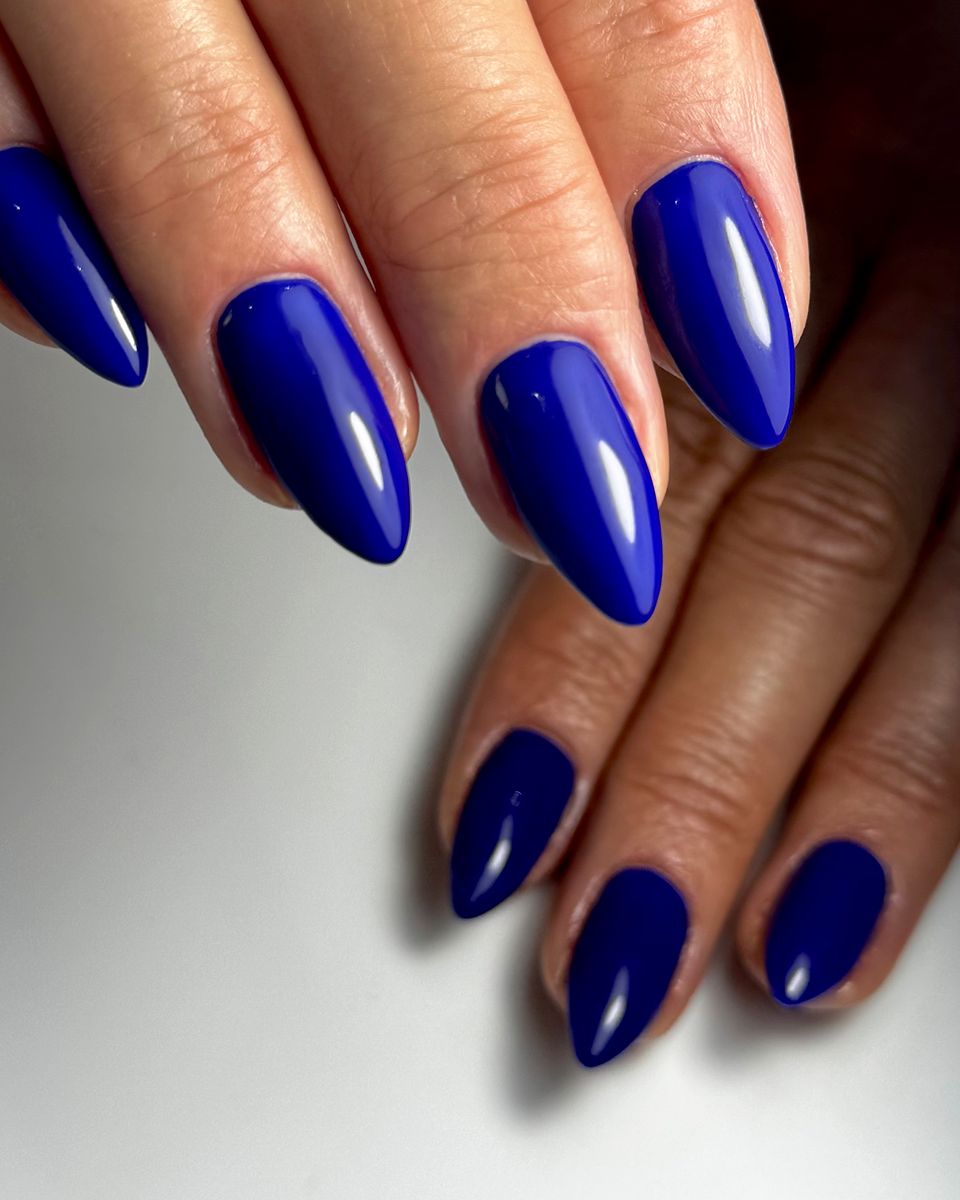 Royal blue glossy almond nails by The Nail Editor
