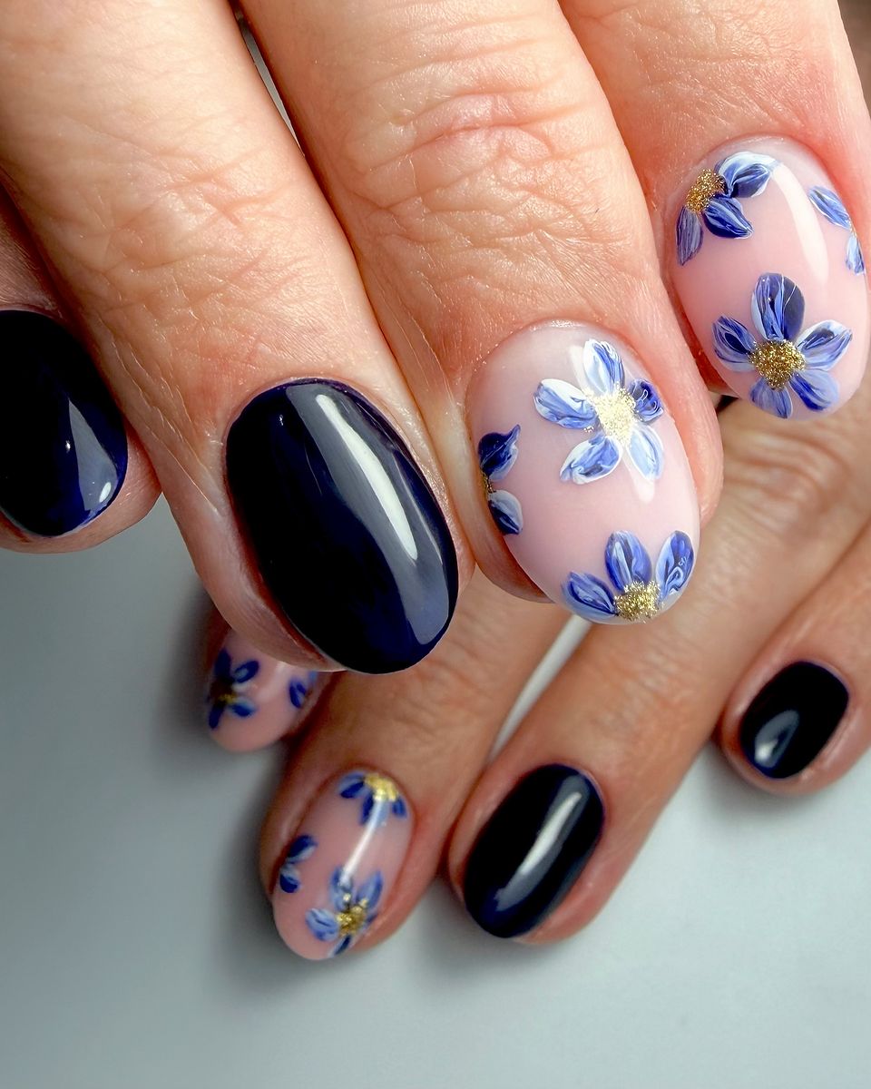Black nails with lilac floral art by The Nail Editor